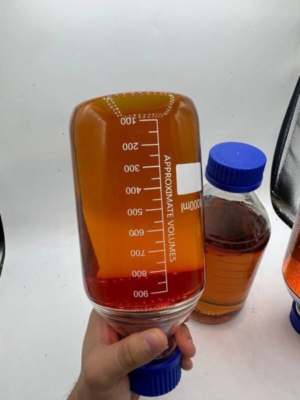A sleek, amber glass bottle of CAT 3 D9 THC Liquid with a black dropper cap, placed on a wooden surface with cannabis leaves in the background.